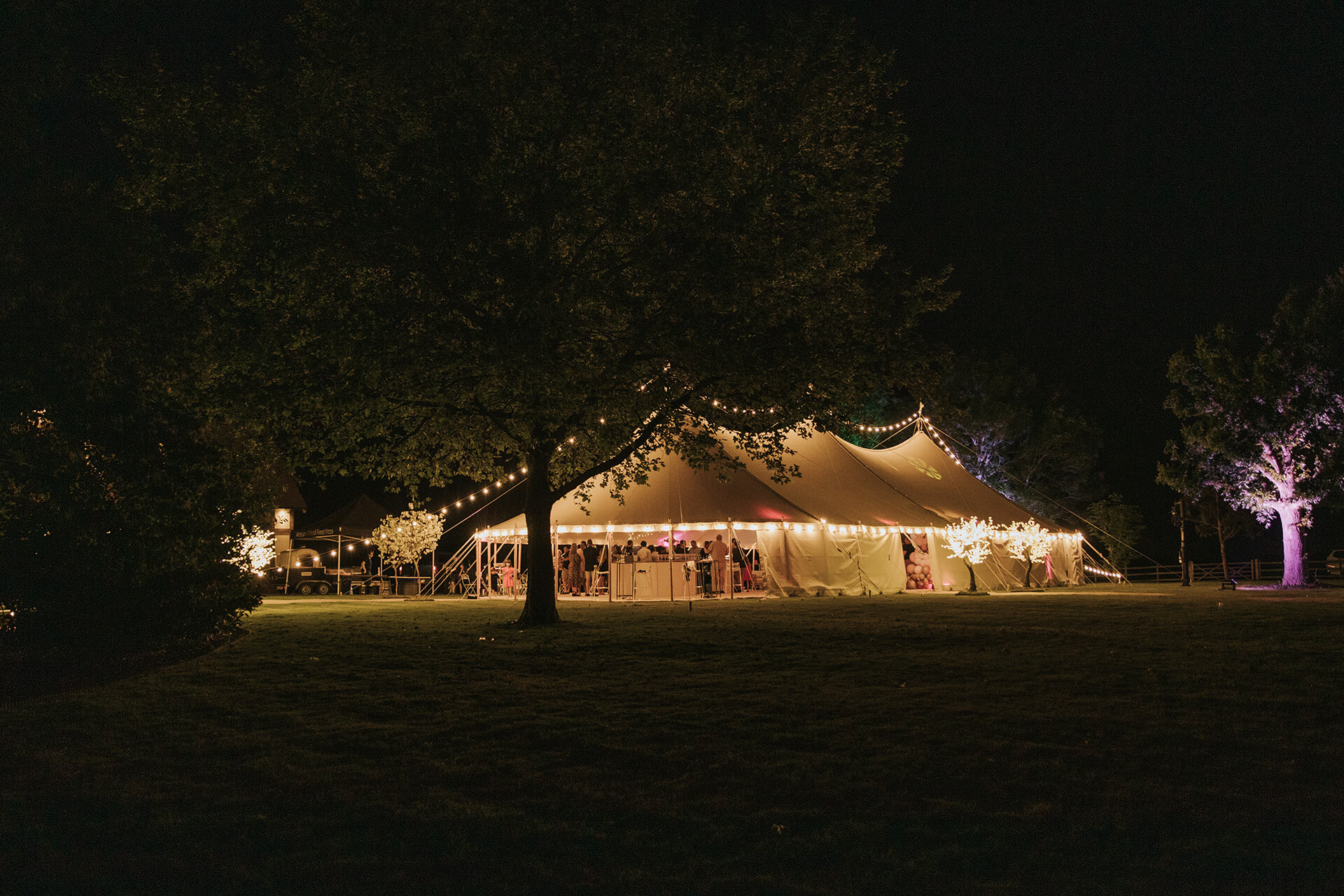 English countryside wedding marquee illuminated at night beneath the English summer skies