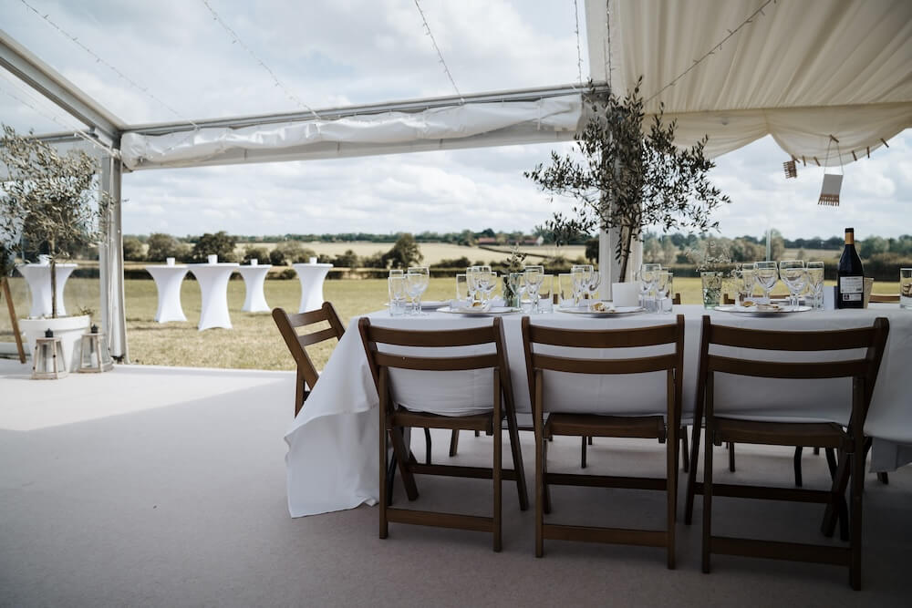 Marquee wedding dining area overlooking the English countryside