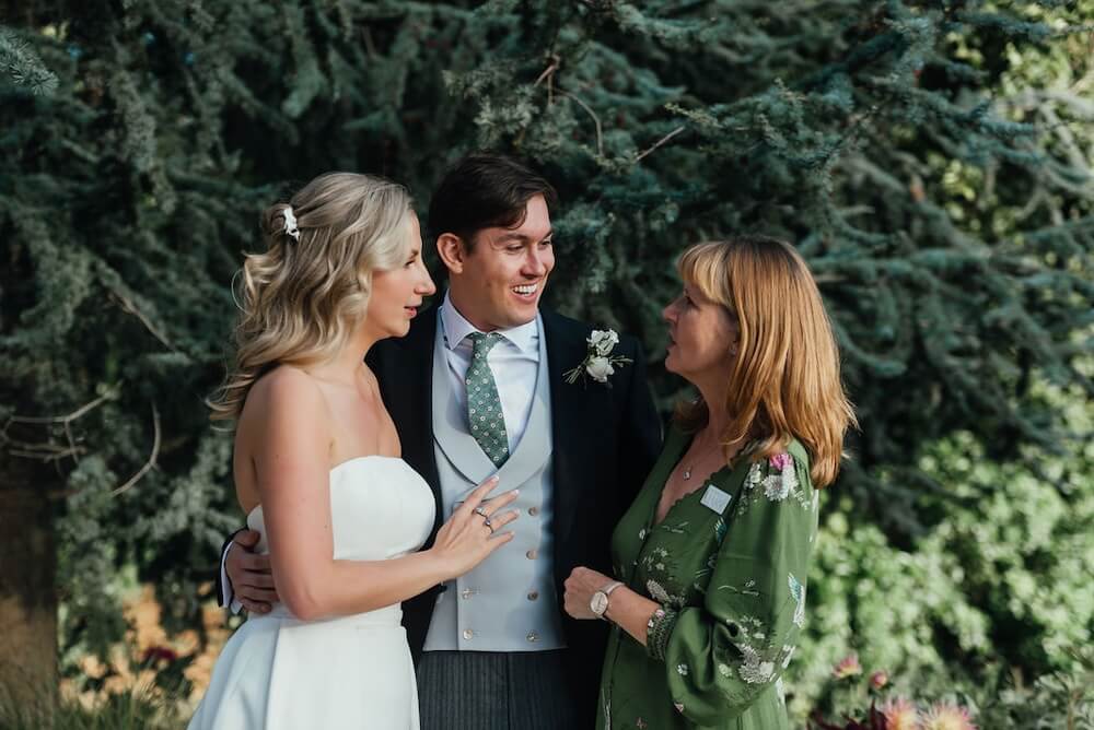UK wedding planner Mary Briscoe with a bride and groom at their Suffolk countryside wedding