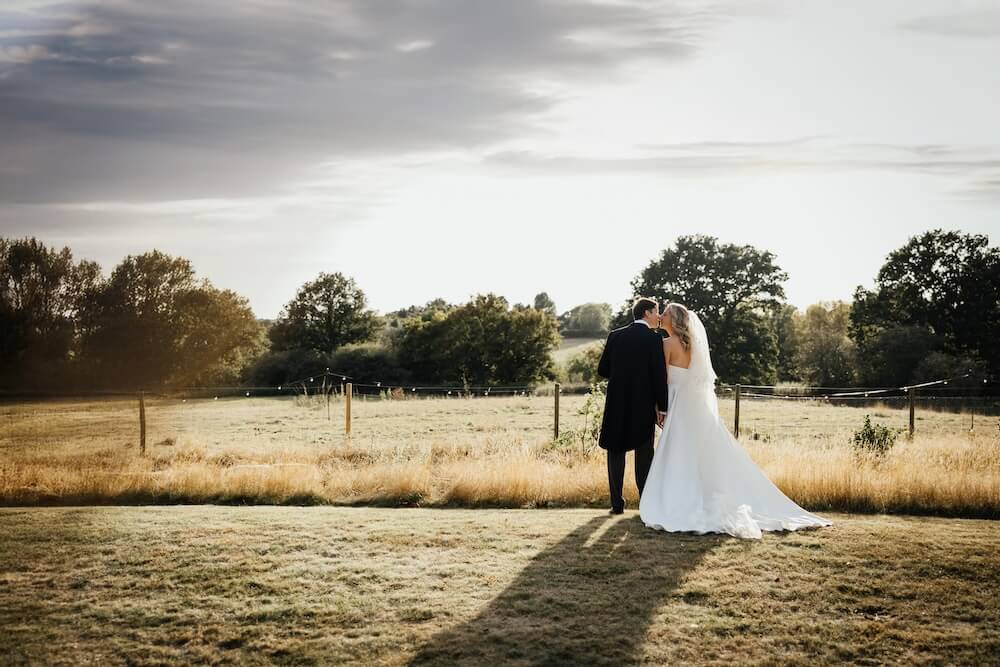 Bride and groom in the countryside at their Suffolk English marquee wedding